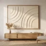 A textured canvas artwork that looks expensive, with refined sculpted arcs in warm cream, in a thin oak float frame above a sideboard