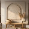 A neutral boho wall artwork with one deeply sculpted arch in warm bone plaster on a greige background, above a rattan bench with a woven basket and pampas grass