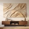 A large abstract plaster wall artwork with dramatic sweeping topographic ridges in warm sand and ivory, hanging above a low walnut console