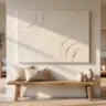 A well-made DIY plaster canvas with clean edges and confident sculpted texture in warm white, hanging above a wooden bench, tools nowhere in sight